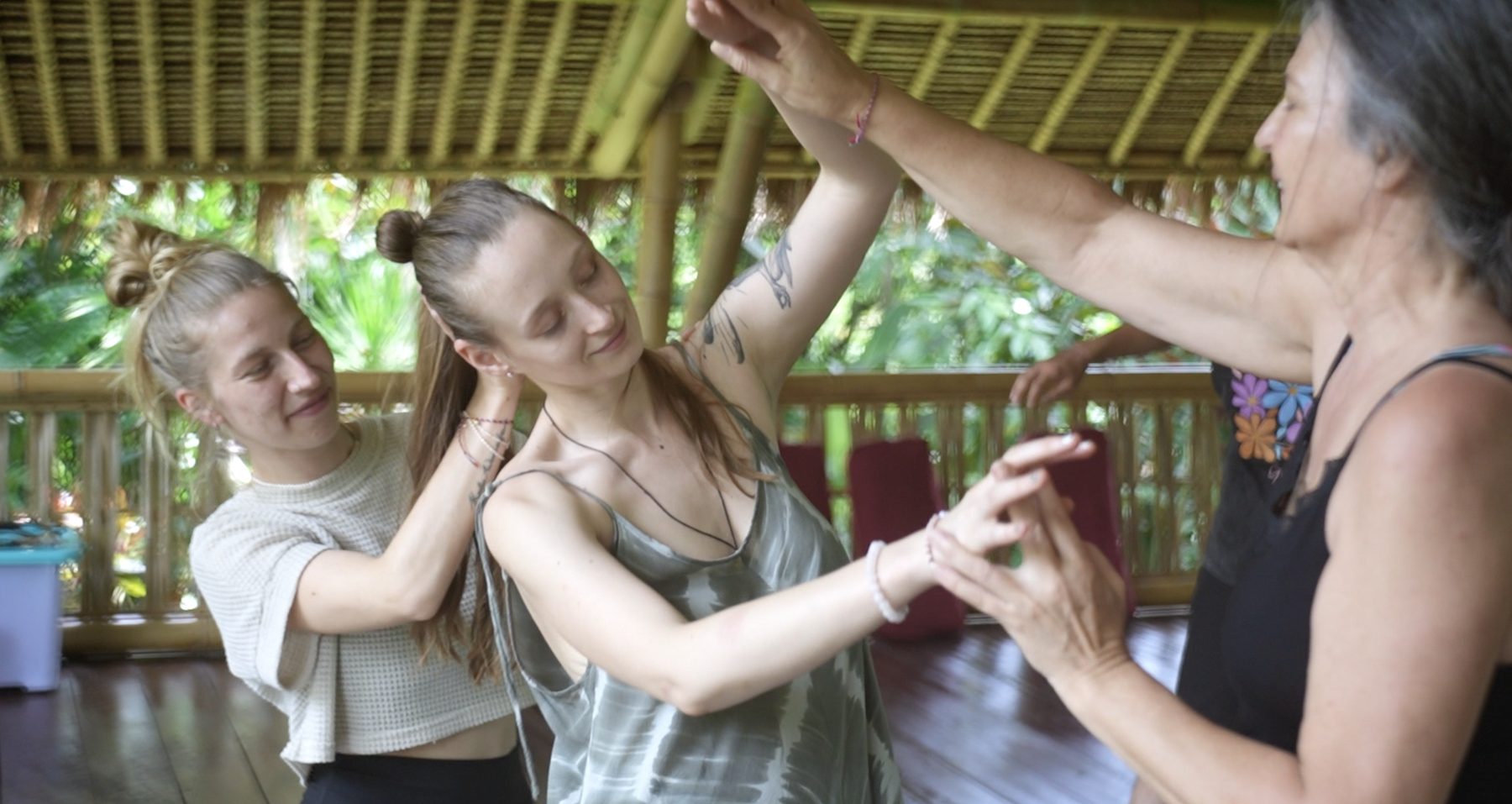 Participants exploring movement together in the bamboo shala