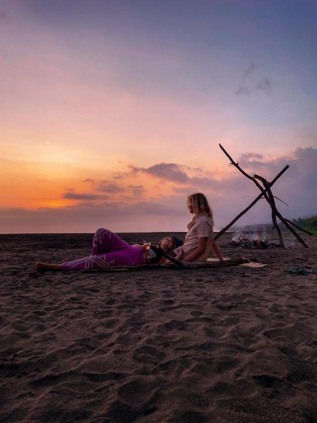 A quiet sunset gathering on the beach near Desa Cabins