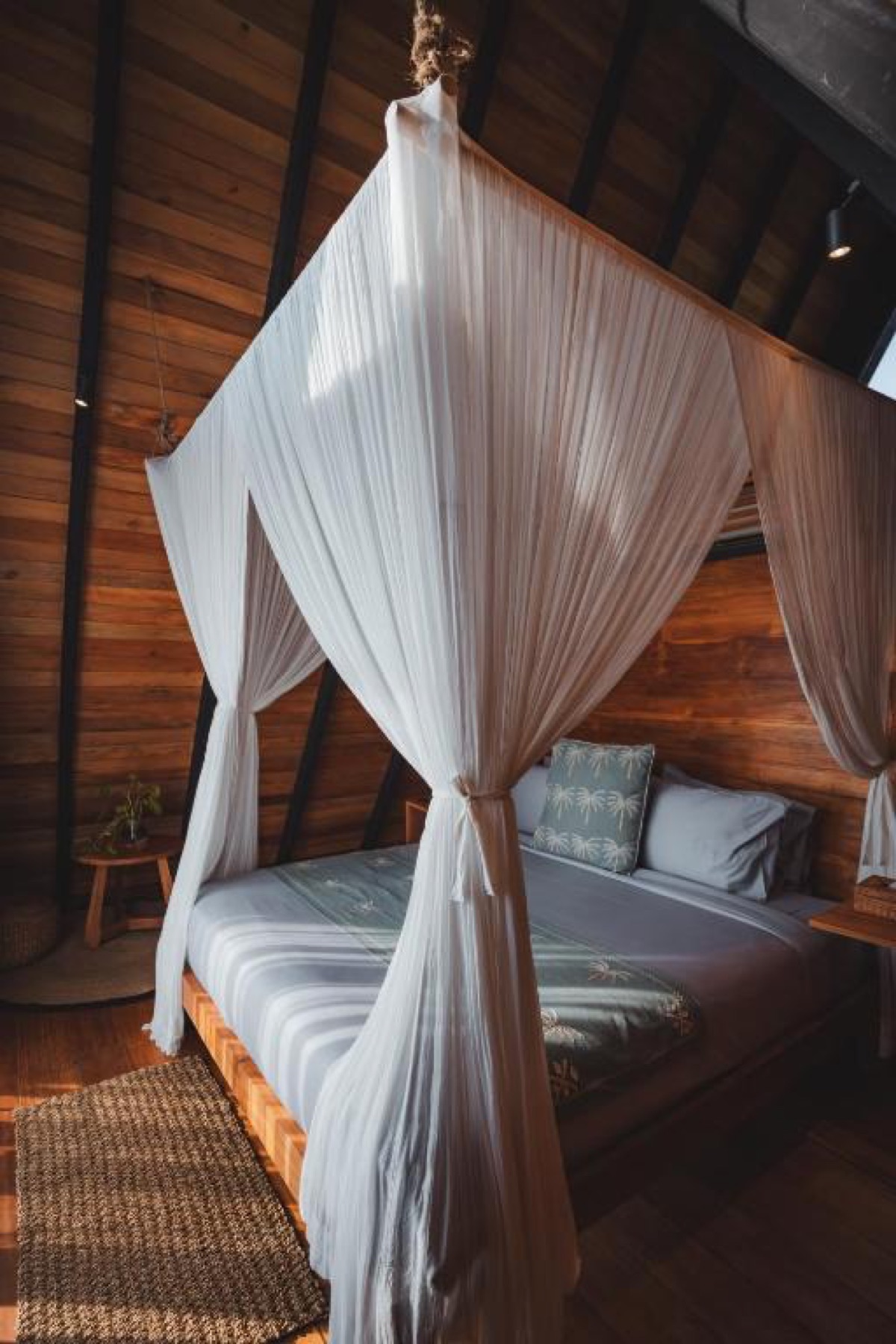 Canopy bed inside a cabin at Desa Cabins