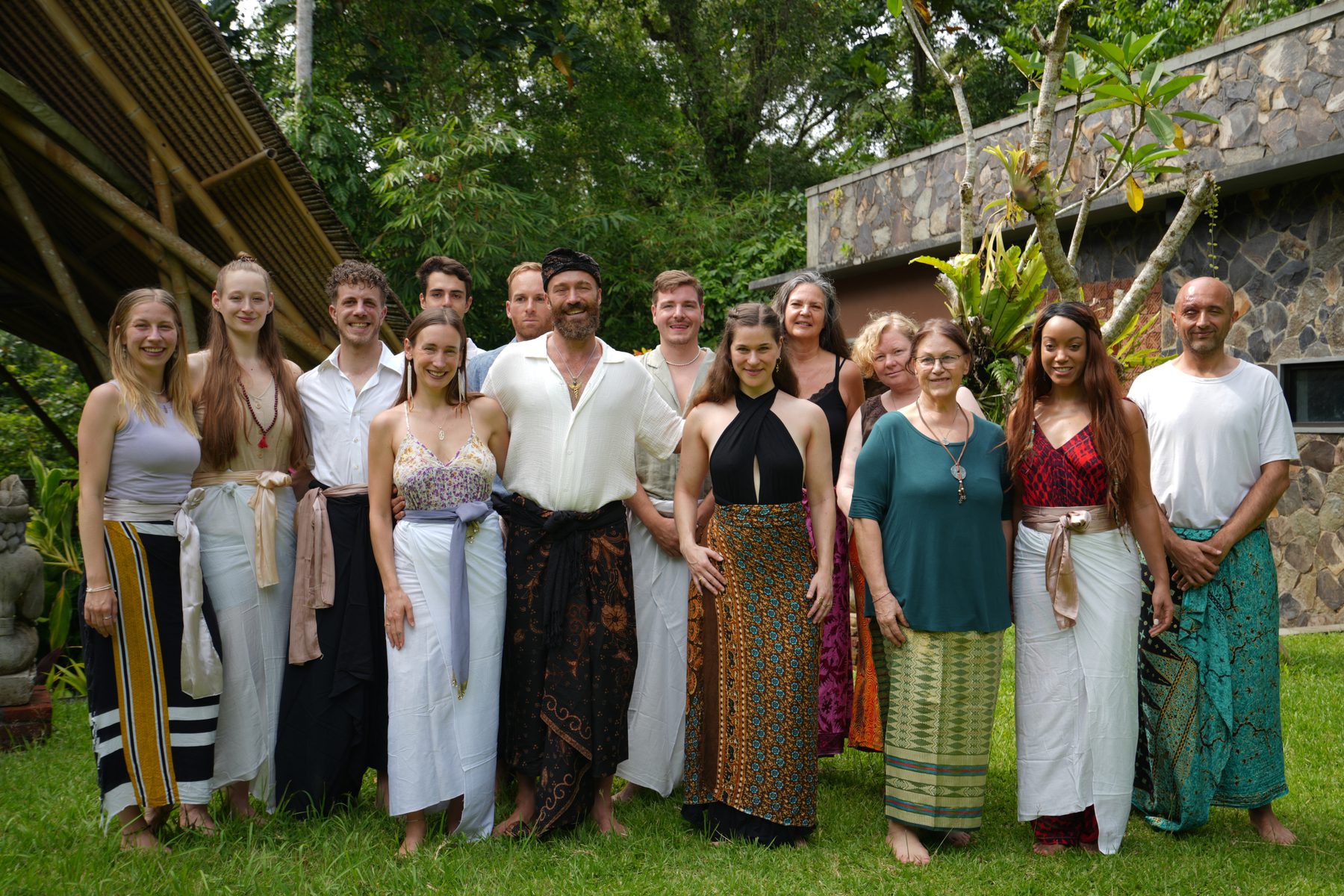 The Gaia Bali community standing together in colourful sarongs