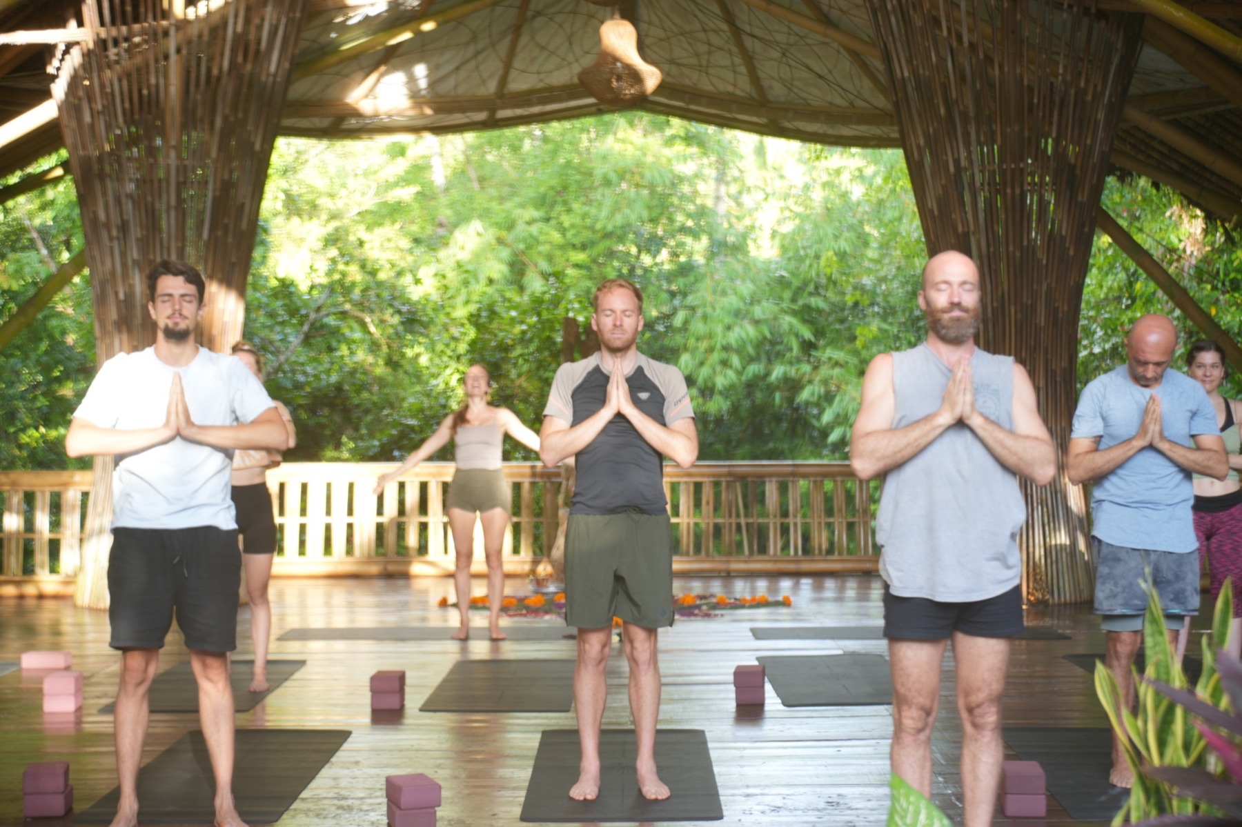 Participants standing together in a quiet embodied practice
