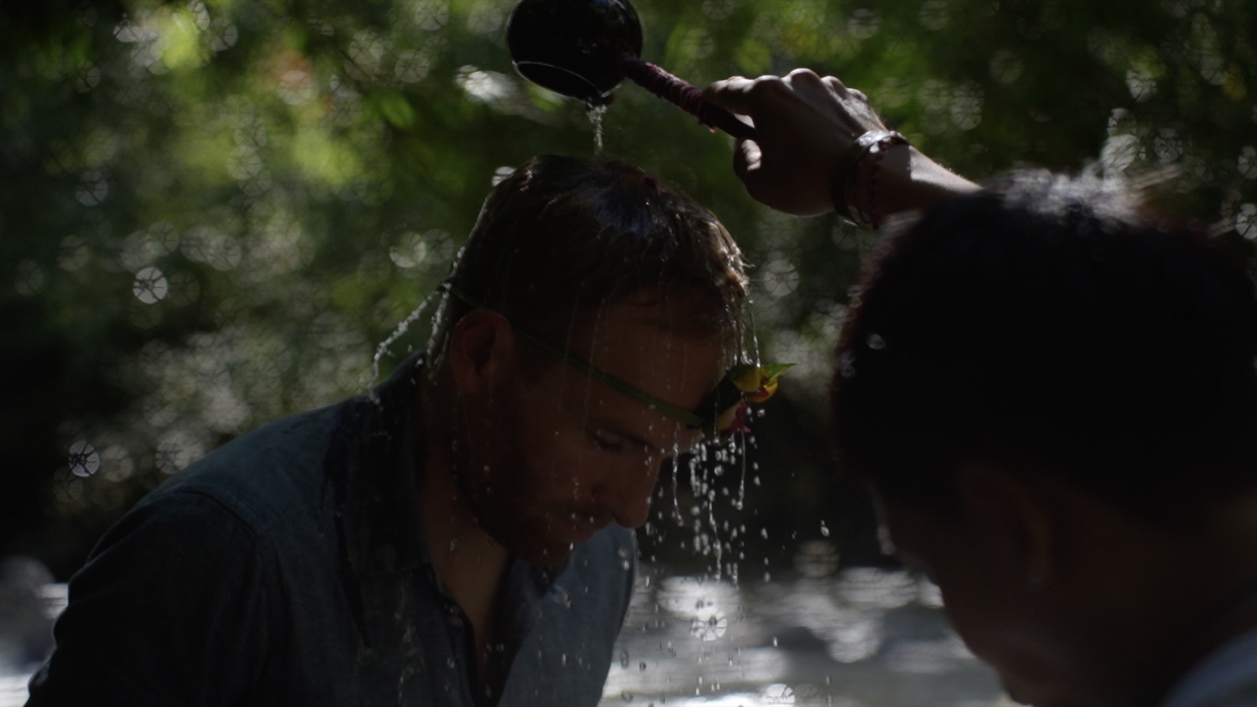 A participant receiving a Balinese water blessing