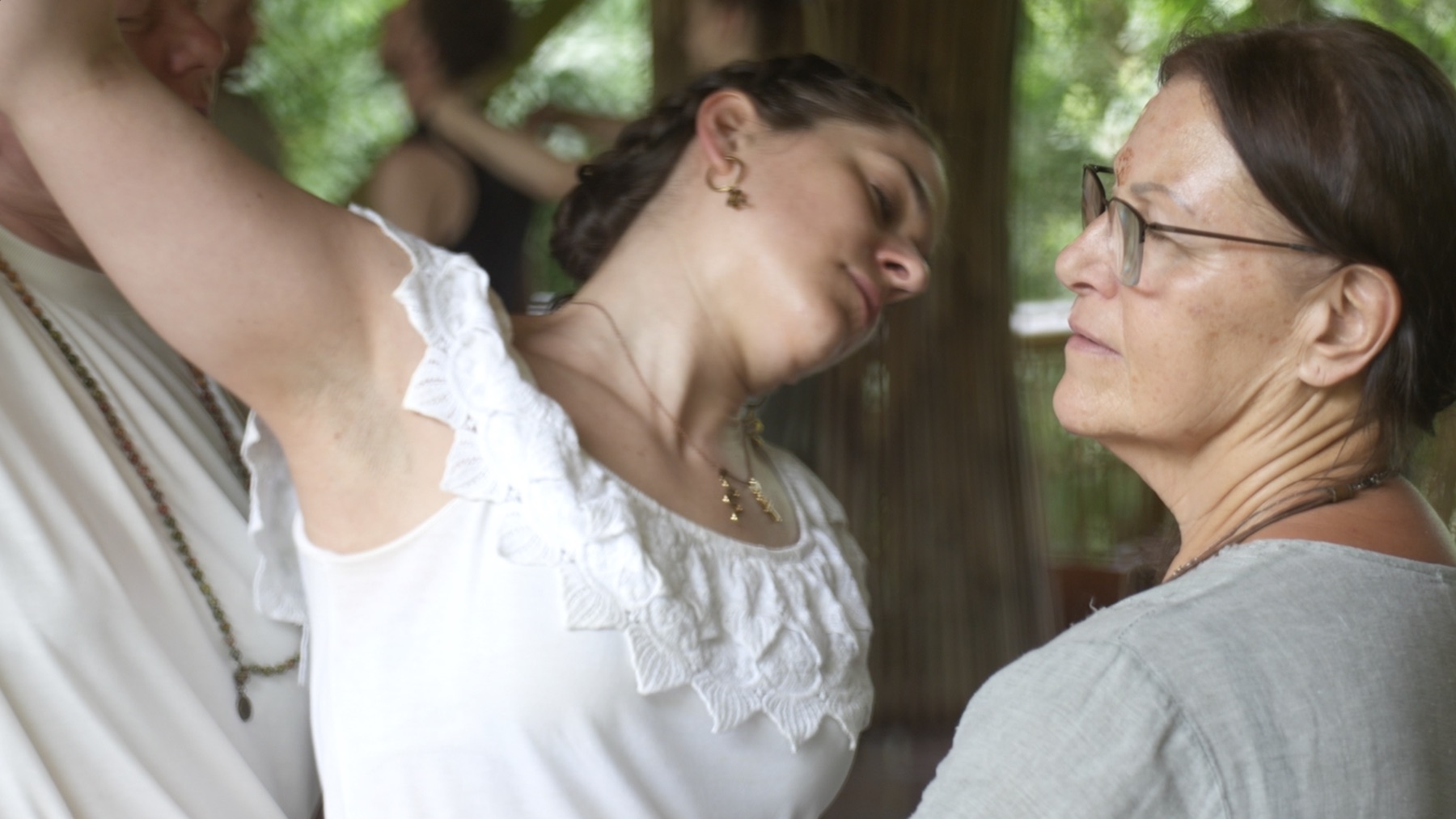 Participants holding and supporting one another through expressive movement